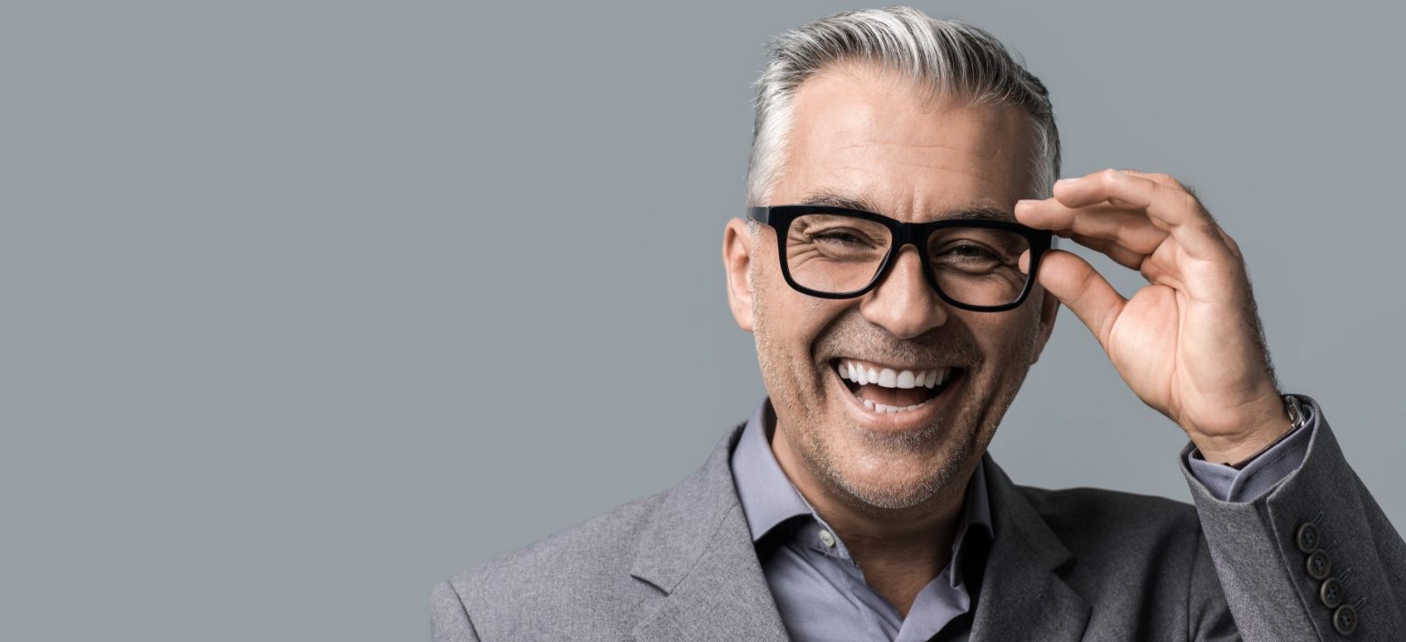 Middle aged man with glasses laughing