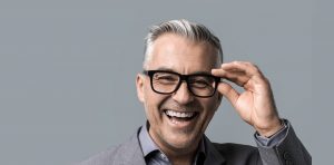 Middle aged man with glasses laughing